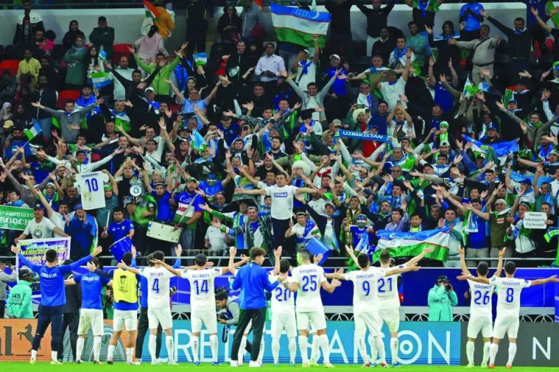 
Uzbekistan’s players celebrate in front of their fans after victory over India. (AFP) 