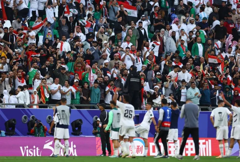 Iraq players celebrate in front of their fans after the match. REUTERS