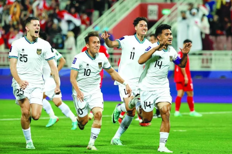 Indonesia’s Asnawi Mangkualam (right) wheels away in celebration with his teammates after scoring from the penalty spot during the 
AFC Asian Cup Group D match against Vietnam at the Abdullah Bin Khalifa Stadium on Friday. (AFP)