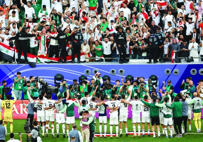 
Iraq players celebrate in front of their fans after the match. (Reuters) 