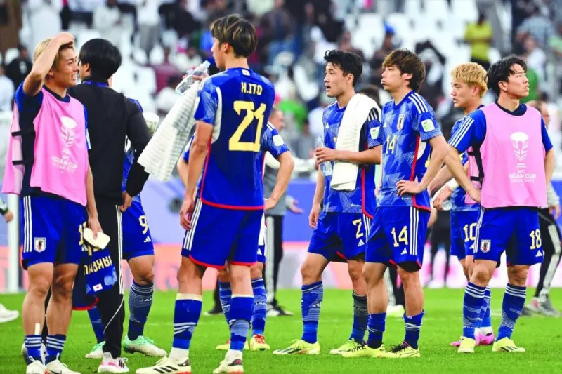 Dejected Japan’s players at the end of the match on Friday. (AFP)