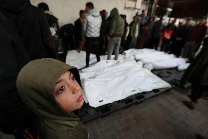 A child looks on as mourners react next to the dead bodies including four Palestinians killed in an Israeli strike on a car, in Rafah in the southern Gaza Strip, Sunday. REUTERS