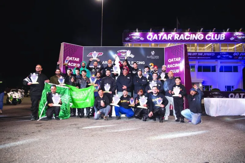 Prize winners pose for a group photograph at the end of the Second Round of the 2024 Arabian Drag Racing League held at Qatar Racing Club.