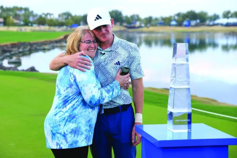 Nick Dunlap of the US hugs his mother, Charlene, after winning The American Express at Pete Dye Stadium Course in La Quinta, California. (AFP)