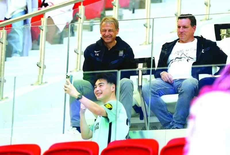
South Korea coach Jurgen Klinsmann (top) poses for a pic during the AFC Asian Cup match between Japan and Indonesia at the 
Al Thumama Stadium in Doha. (Reuters) 
