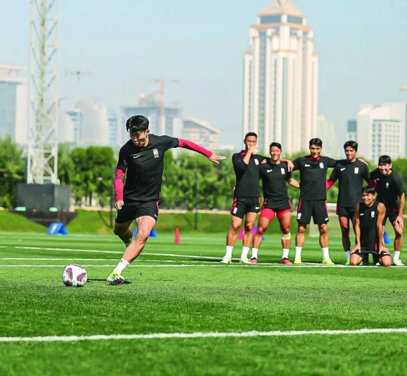 South Korea’s captain and forward Son Heung-min practices free kick as teammates look on during a training session in Doha on Wednesday, ahead of their Asian Cup final group stage match against Malaysia.