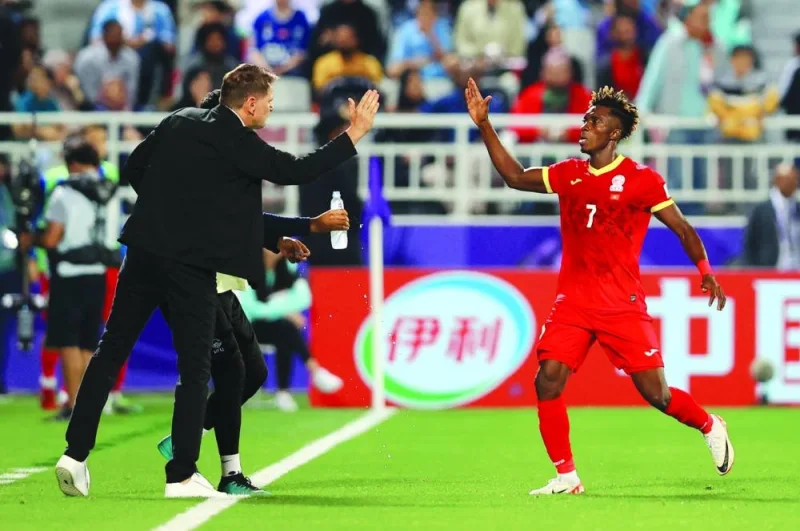 
Kyrgyzstan’s Joel Kojo (right) celebrates with coach Stefan Tarkovic after scoring against Oman at the Abdullah Bin Khalifa Stadium. (Reuters) 
