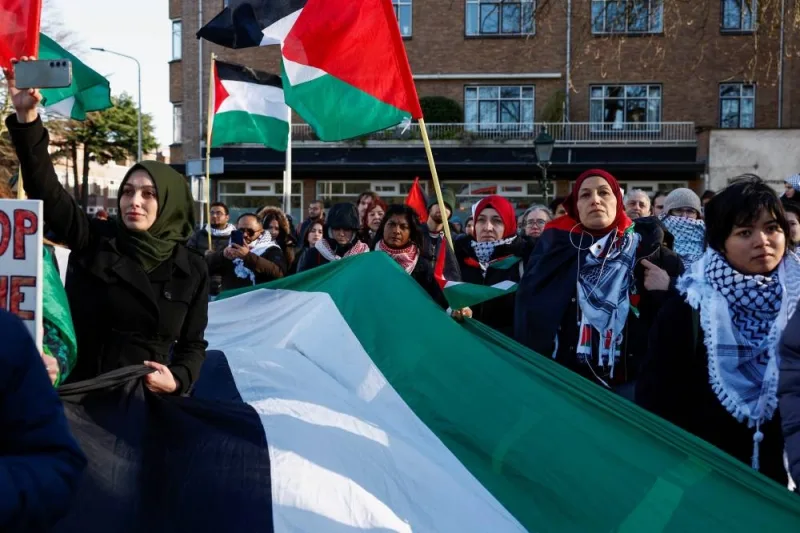 People hold flags during a pro-Palestinian demonstration outside the International Court of Justice (ICJ) as judges rule on emergency measures against Israel following accusations by South Africa that the Israeli military operation in Gaza is a state-led genocide, in The Hague, Netherlands, on Friday. REUTERS