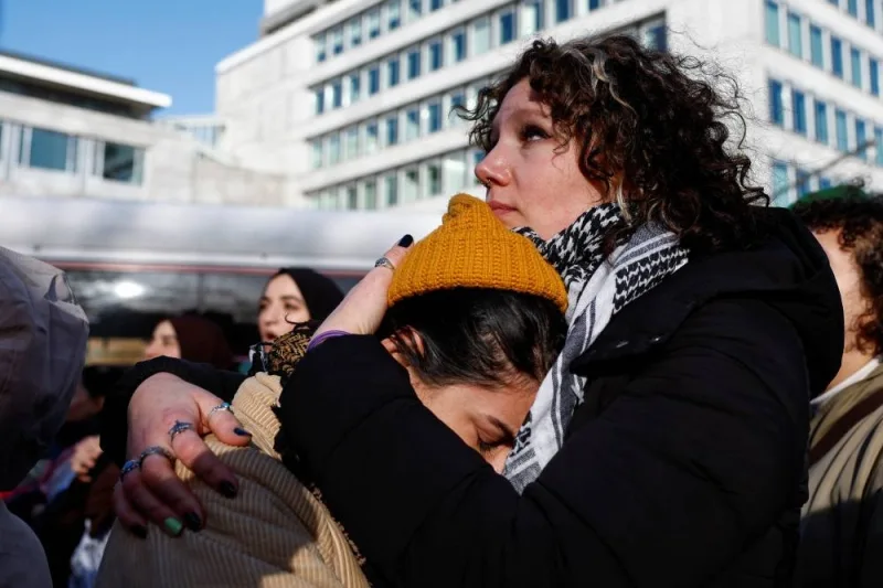 People comfort each other during a pro-Palestinian demonstration outside the International Court of Justice (ICJ) as judges rule on emergency measures against Israel following accusations by South Africa that the Israeli military operation in Gaza is a state-led genocide, in The Hague, Netherlands, on Friday. REUTERS