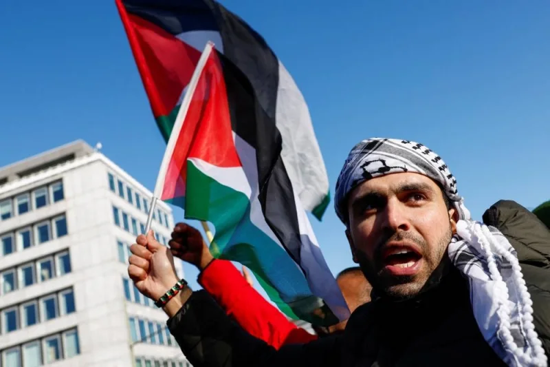 A person holds a flag during a pro-Palestinian demonstration outside the International Court of Justice (ICJ) as judges rule on emergency measures against Israel following accusations by South Africa that the Israeli military operation in Gaza is a state-led genocide, in The Hague, Netherlands, on Friday. REUTERS
