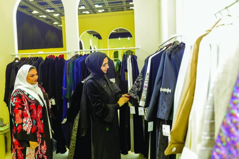 Al-Ahmadani is viewing the products on display.
