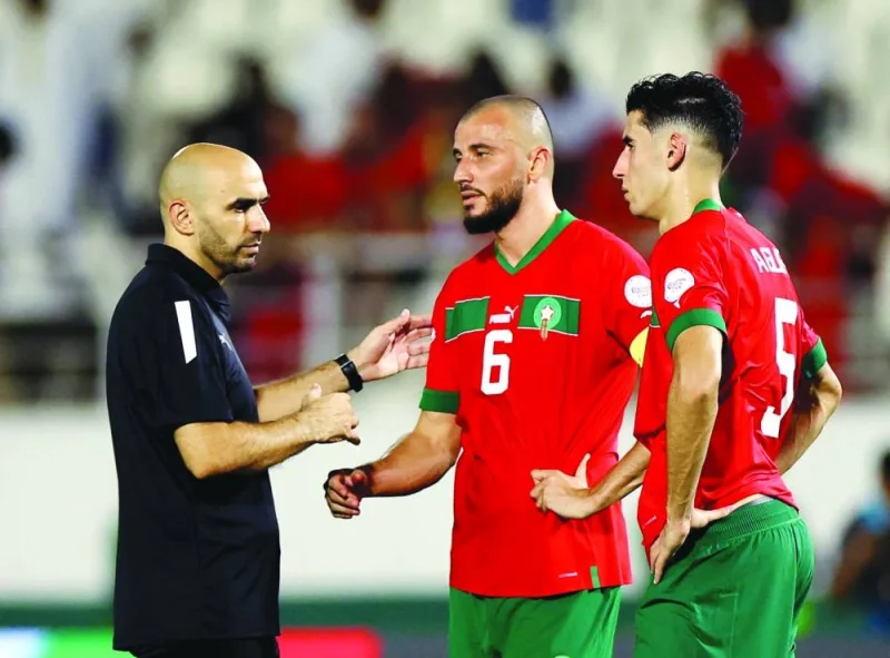 Morocco coach Walid Regragui, Romain Saiss and Nayef Aguerd look dejected after the Africa Cup of Nations - Round of 16 - match against South Africa at Laurent Pokou Stadium, San Pedro, Ivory Coast, on Tuesday. (Reuters)