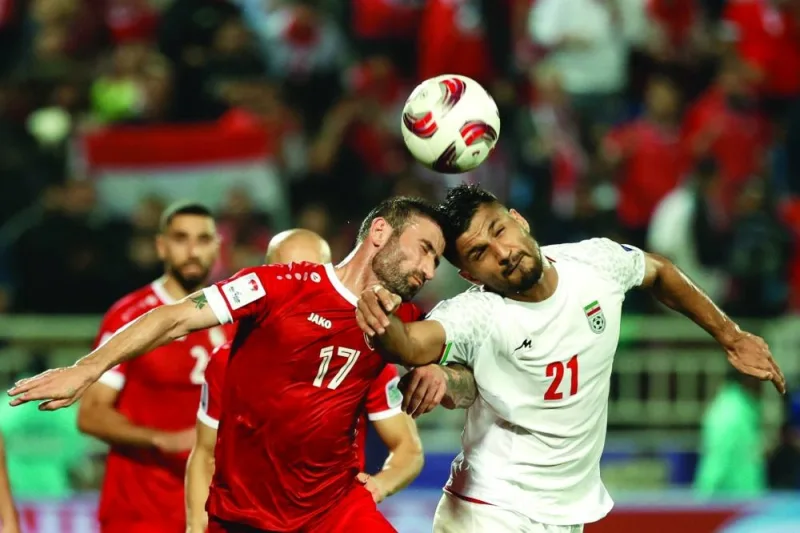 
Syria’s Fahd Youssef (left) and Iran’s Mohamed Mohebi vie for the ball during the Asian Cup. (AFP) 