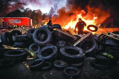 
Dutch and Belgian farmers burn wooden pallets and tyres as they block the border crossing in Arendonk between Belgium and the Netherlands. 