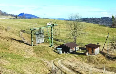 
The bottom of the closed Dent-de-Vaulion ski lift is seen amid a lack of snow at altitudes below 1,500m due to high winter temperatures induced by climate change, in Vaulion, Switzerland. 