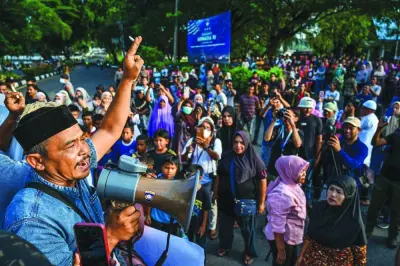 
Local residents protest against the arrival of Rohingya refugees near a temporary camp where they are staying at a port in Sabang island, Indonesia’s Aceh province. 