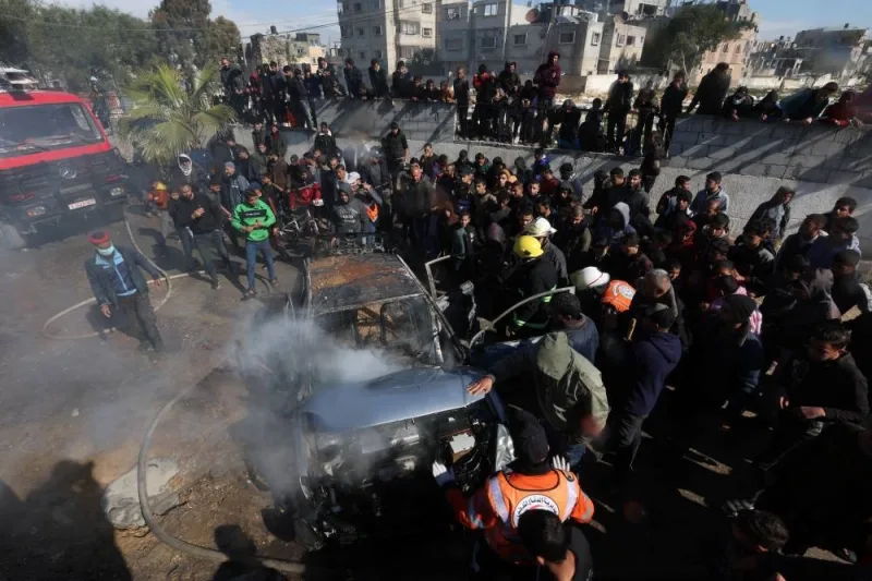 Palestinians inspect a car hit in an Israeli strike in Rafah on Sunday. REUTERS