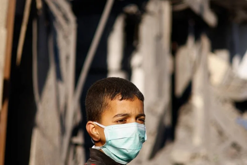 A Palestinian child looks at the site of an Israeli strike on a residential building in Rafah on Sunday. REUTERS