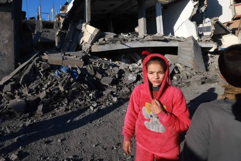 A child stands in front of a building destroyed in Israeli bombardment on Rafah in the southern Gaza Strip on Sunday. AFP