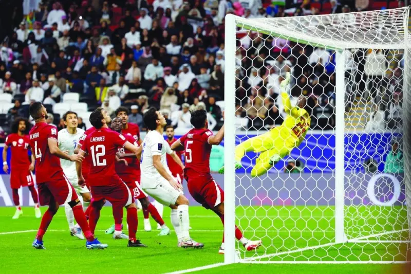 
Qatar’s goalkeeper Meshaal Barsham (in yellow) dives to secure the ball during the 2023 AFC Asian Cup quarter-final against Uzbekistan at Al Bayt Stadium on Saturday. (AFP) 