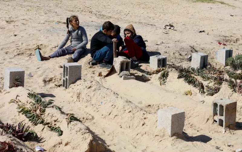Displaced Palestinian children, who fled their houses due to Israeli strikes, play in a cemetery where they shelter, amid the ongoing conflict between Israel and Hamas, in Rafah in the southern Gaza Strip, Monday. REUTERS