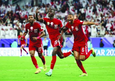 Qatar&#039;s Almoez Ali (centre) celebrates scoring their third goal with teammates during their AFC Asian Cup semi-final against Iran at Al Thumama Stadium in Doha Wednesday. REUTERS