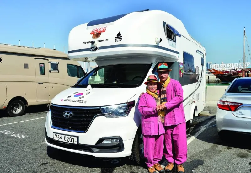 The travellers pose for Gulf Times next to their van on Doha Corniche Friday. PICTURE: Shaji Kayamkulam