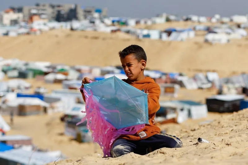 A displaced Palestinian boy prepares a kite amid the ongoing conflict between Israel and Palestinian Islamist group Hamas in Rafah on Thursday. REUTERS