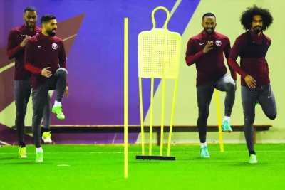 
Qatar players warm-up during a training session at the Aspire. 