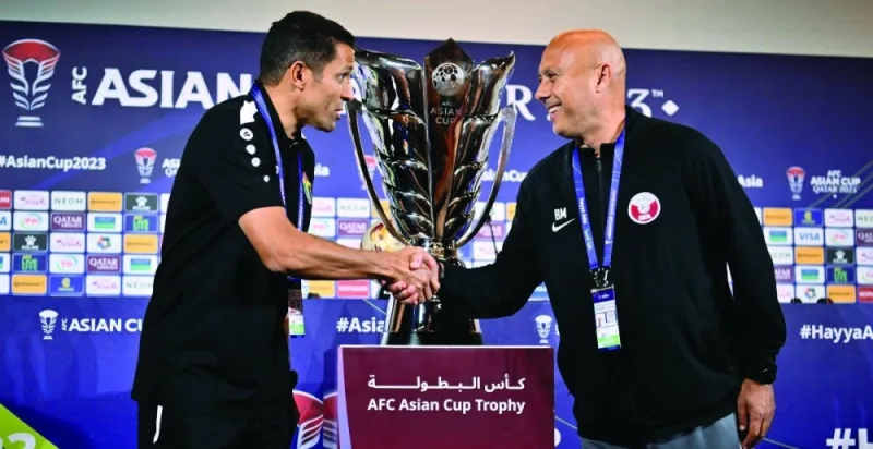 Qatar’s coach Marquez Lopez (right) and his Jordan counterpart Hussein Ammouta greet each other on Friday, on the eve of the AFC Asian Cup final.