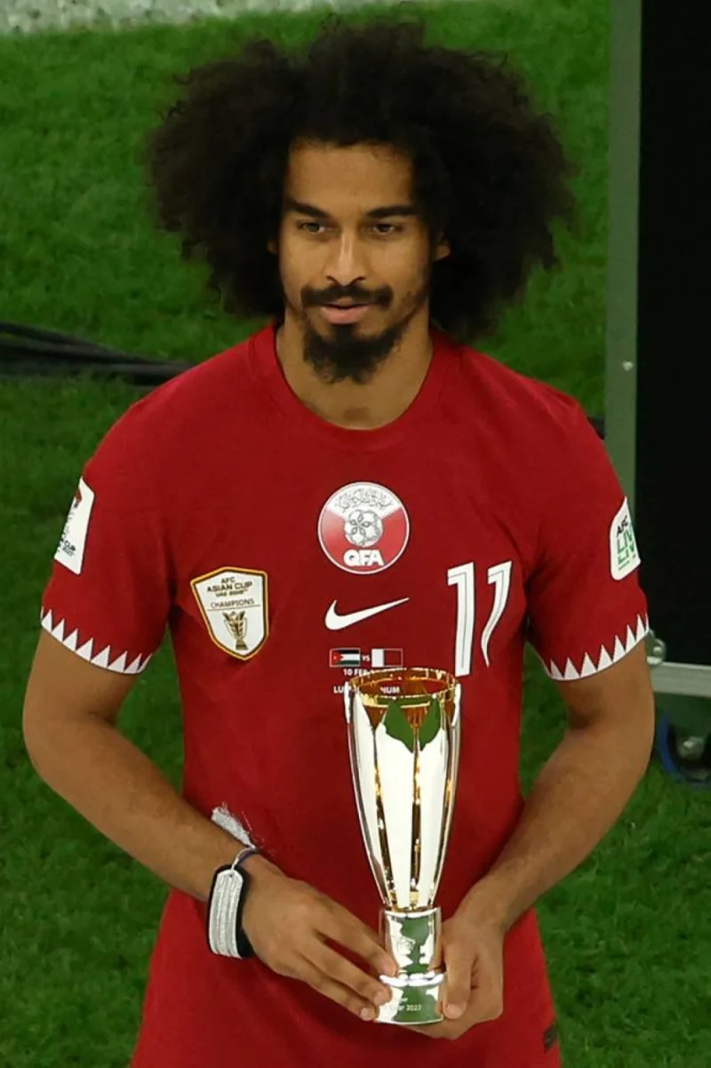 Qatar&#039;s forward #11 Akram Afif celebrates with the Most Valuable Player Award trophy during the podium ceremony after the AFC Qatar 2023 Asian Cup final football match between Jordan and Qatar at the Lusail Stadium.