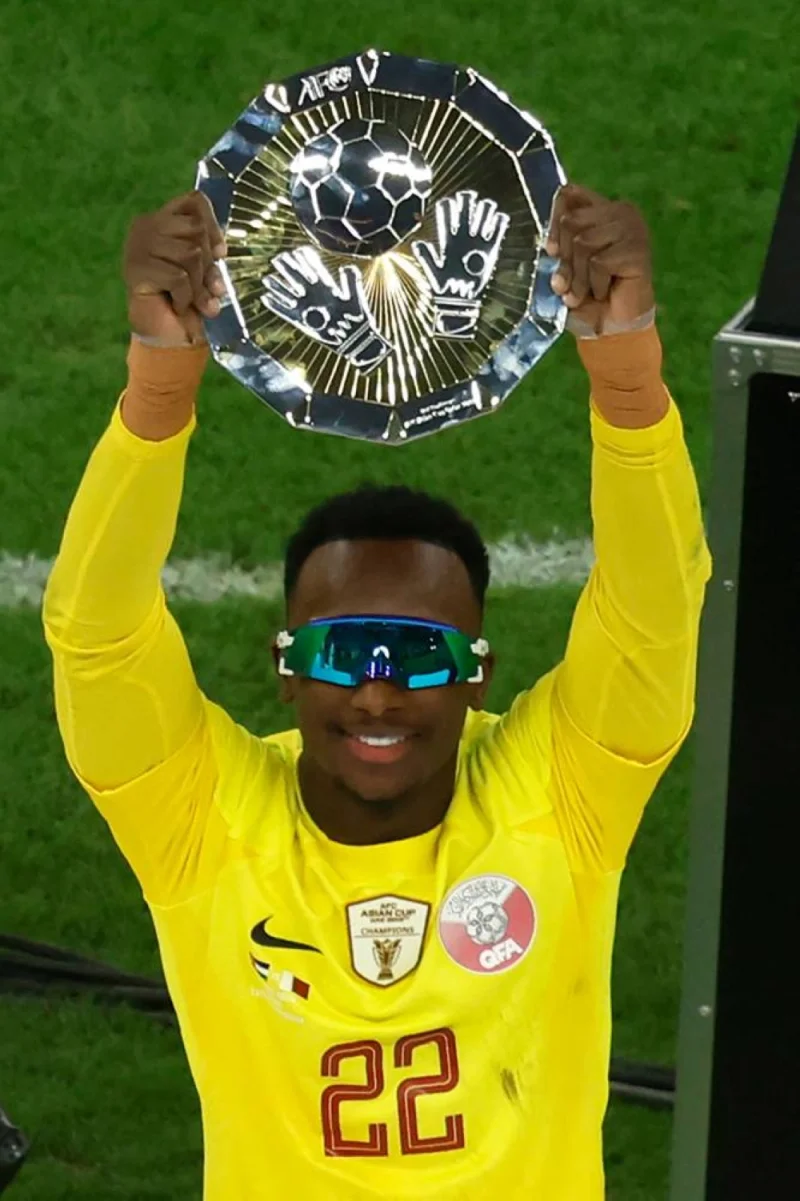 Qatar&#039;s goalkeeper #22 Meshaal Barsham celebrates with the Best Goalkeeper Award trophy during the podium ceremony after the AFC Qatar 2023 Asian Cup final football match between Jordan and Qatar at the Lusail Stadium.