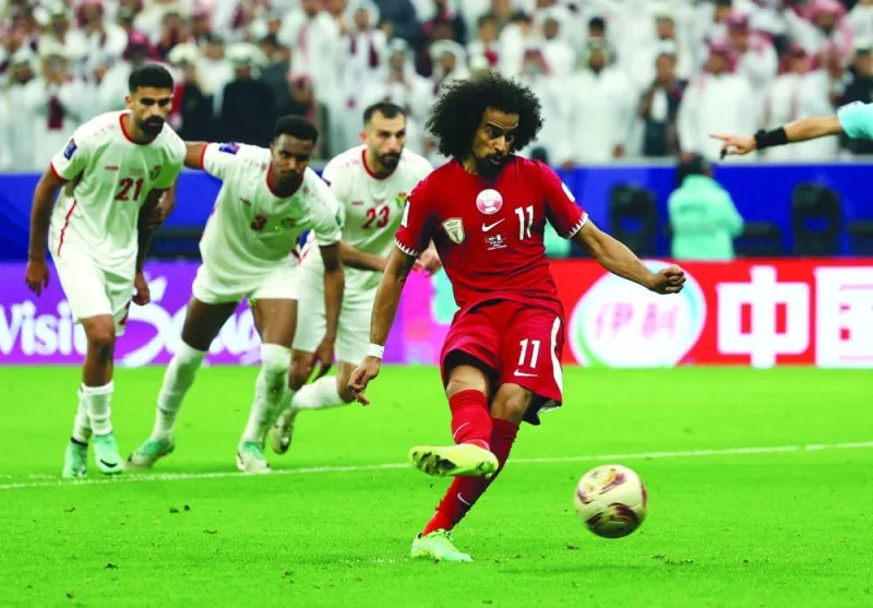 
Qatar’s Akram Afif scores from the penalty spot to complete his hat-trick. 