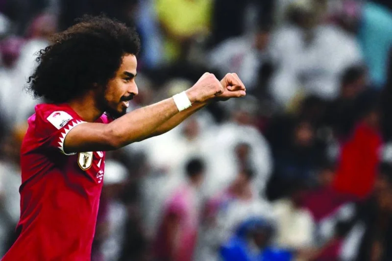 Qatar&#039;s hat trick scorer forward #11 Akram Afif celebrates after his team won the AFC Qatar 2023 Asian Cup final football match between Jordan and Qatar at the Lusail Stadium in Lusail, north of Doha on February 10, 2024. (Photo by Jewel SAMAD / AFP)