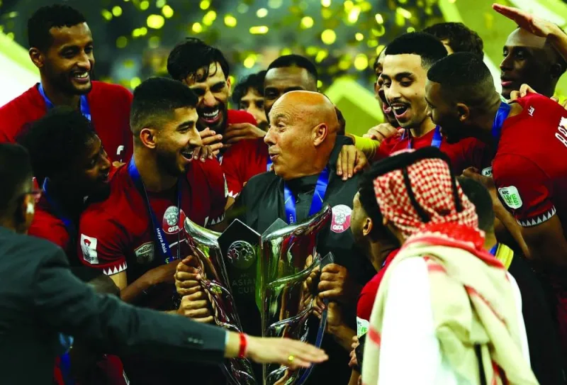 
Qatar coach Marquez Loepz lifts the trophy after winning the AFC Asian Cup final against Jordan at Lusail Stadium on Saturday. (Reuters) 