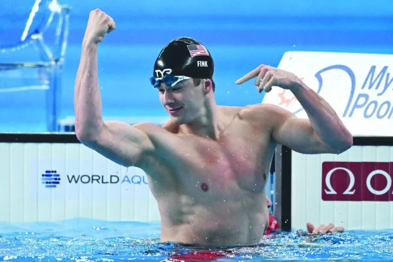 Nic Fink of the US celebrates after winning the men’s 100m breaststroke final during the World Aquatics Championships Doha at the Hamad Aquatic Centre on Monday. (AFP)