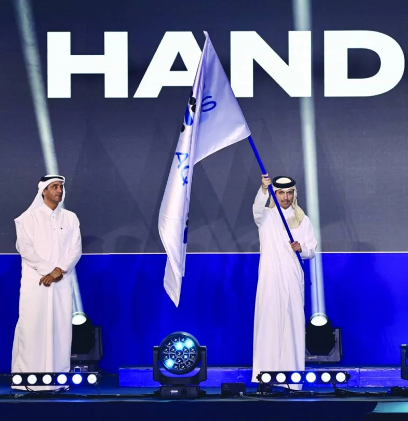 Vice Chairperson of the Organising Committee of Doha 2024, Jassim bin Rashid al-Buainain, waves the World Aquatics flag during the host city handover ceremony in Doha yesterday. Singapore will host the World Aquatics Championships in 2025.
