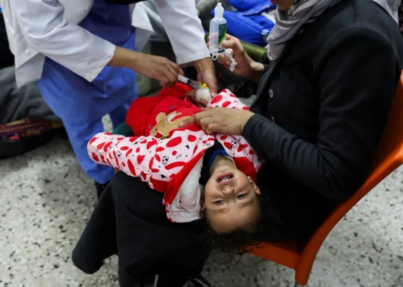 A Palestinian child is treated by a doctor at a health center in Rafah in the southern Gaza Strip, on Tuesday. REUTERS