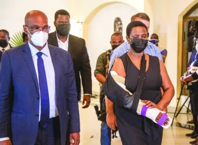
This picture taken on June 22, 2021 shows Prime Minister Ariel Henry with First Lady Martine Moise as they leave the Catholic ceremony of funeral vigil for President Jovenel Moise at Hotel Roi Christophe, in Cap-Haitien. 