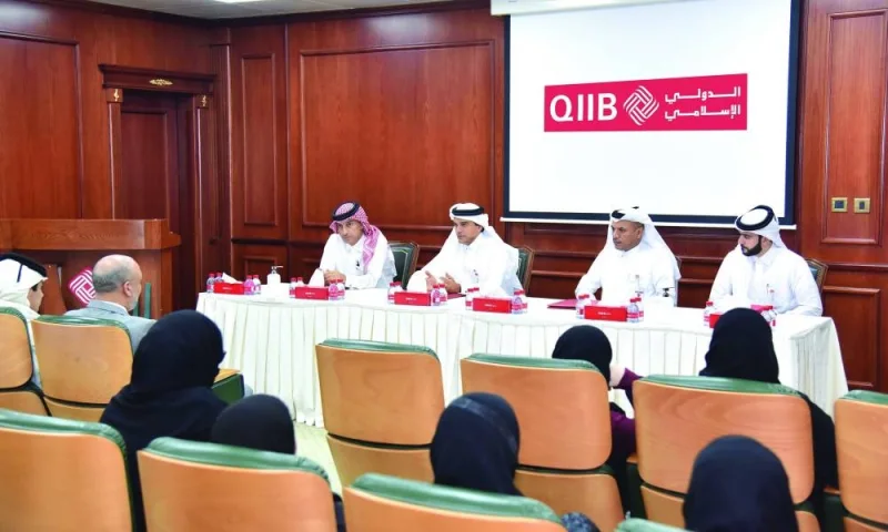 QIIB CEO Dr Abdulbasit Ahmad al-Shaibei and other senior bank executives brief students of Qatar Academy on Islamic banking.