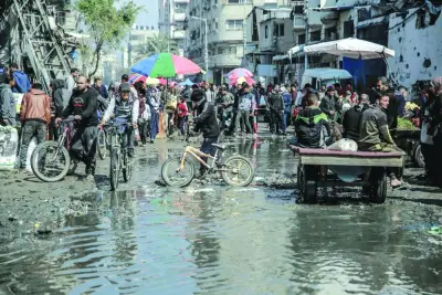 Palestinians crowd at a flooded market area in Gaza City Saturday.