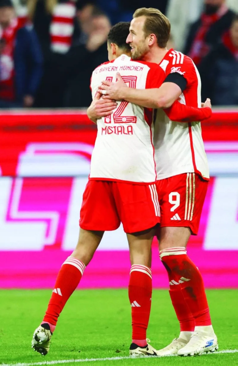 Bayern Munich’s English forward Harry Kane (right) celebrates scoring the opening goal with his teammate Jamal Musiala during the Bundesliga match against RB Leipzig in Munich on Saturday. (AFP)