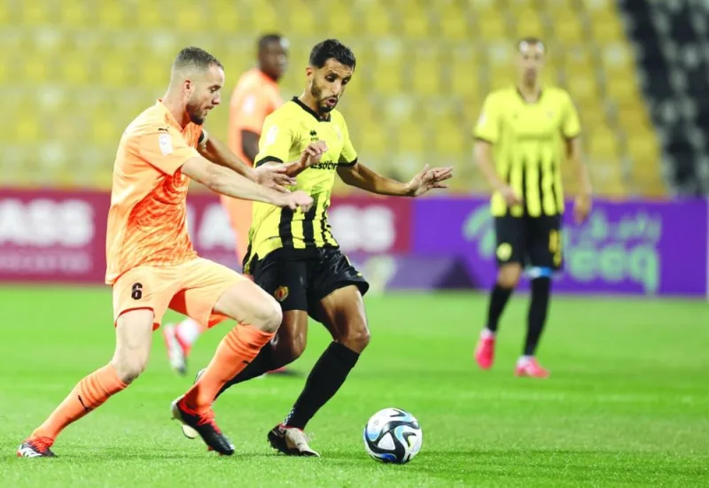 Qatar SC and Umm Salal players vying for the ball during their Expo Stars League match on Saturday.