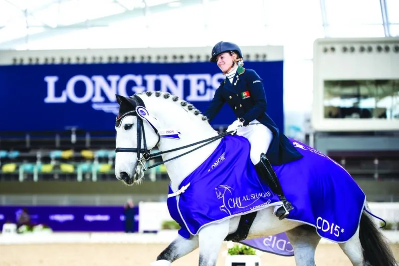 
Maria Caetano celebrates with her horse Horizonte after winning the dressage Grand Prix Special. 