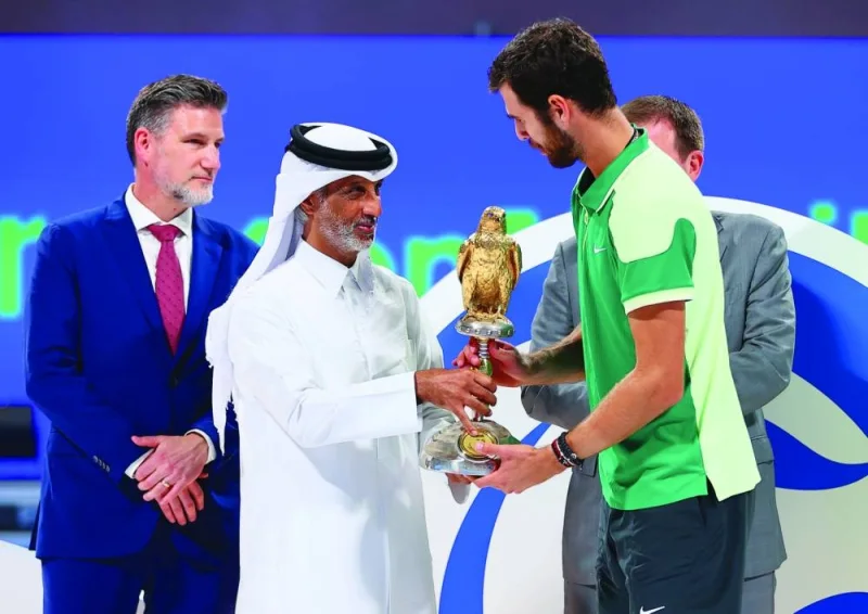 Minister of Sports and Youth HE Sheikh Hamad bin Khalifa bin Ahmed al-Thani presents the trophy to Russia’s Karen Khachanov, winner of the Qatar ExxonMobil Open on Saturday.