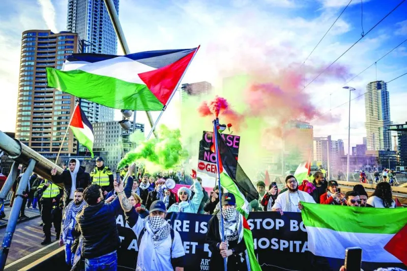Demonstrators hold Palestinian flags during a rally  in solidarity with Palestinians in Rotterdam, Sunday.