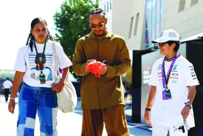 Mercedes’ Lewis Hamilton signs autograph for fans as he arrives at the Bahrain International Circuit on Friday. (Reuters)