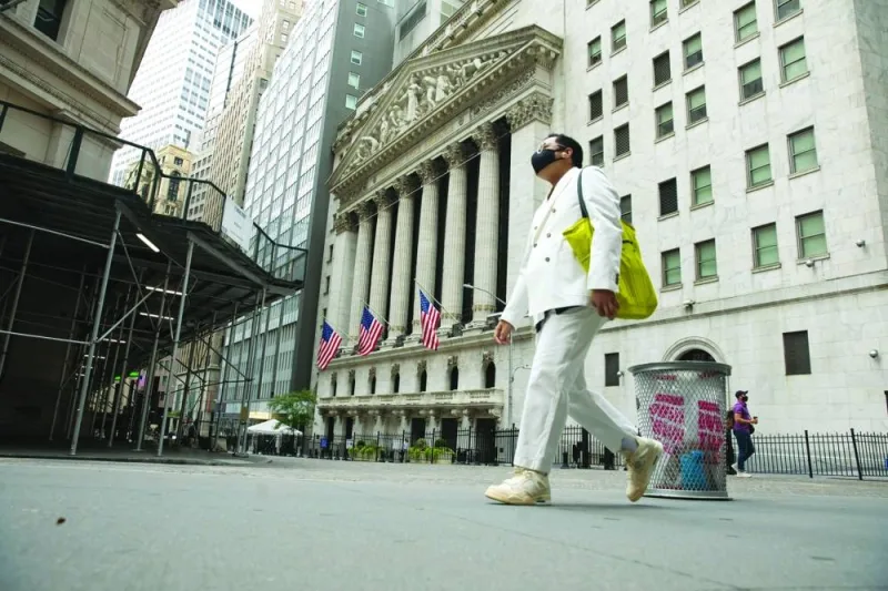 A pedestrian passes in front of the New York Stock Exchange. The frenzy around AI stocks has blindsided Wall Street forecasters, spurring a race among strategists to keep up with a stock market rally that’s already blowing past their expectations when 2024 began.