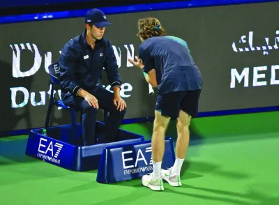 Russia’s Andrey Rublev talks to the line judge during his semi-final against Kazakhstan’s Alexander Bublik at the Dubai Tennis Championships on Friday. Right: Rublev argues with an official after he was defaulted as Bublik looks on. (Reuters/AFP)