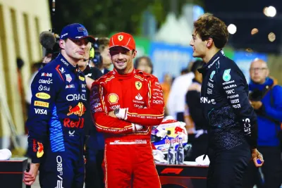 After qualifying in pole position, Red Bull’s Max Verstappen speaks with second-placed Ferrari’s Charles Leclerc and third-placed Mercedes’ George Russell during the Bahrain Grand Prix at the Bahrain International Circuit in Sakhir on Friday. (Reuters)